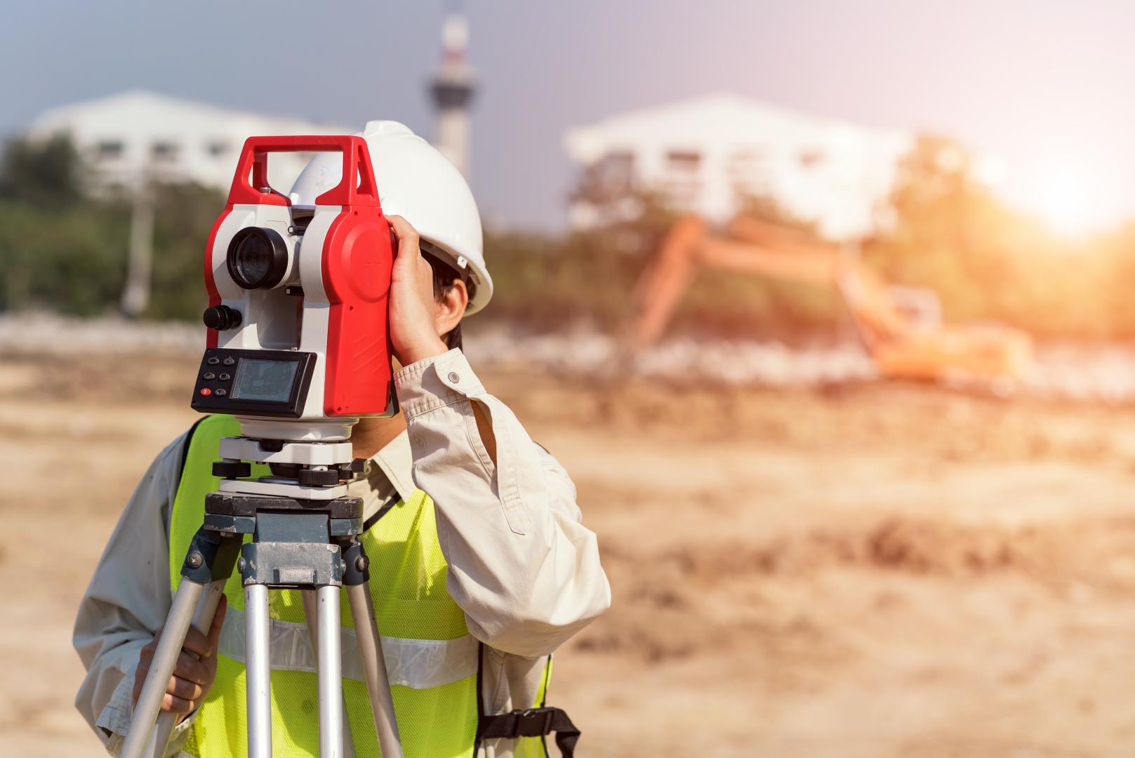 Photo fo a laser scan surveyor using a laser scanner